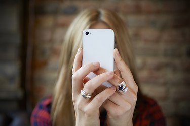 woman taking selfie with cell phone