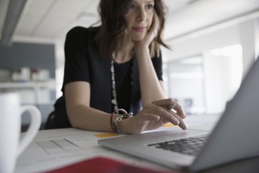 Female architect working at laptop in office