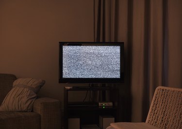 Darkened living room with static noise on TV screen