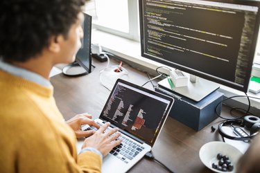 Computer programmer working at his desk