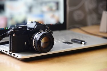 Digital Studio Photography Workstation. Retro film DSLR Camera, Laptop Computer Screen and flash drive memory card