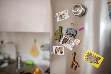Fridge door with colored magnets and polaroid images