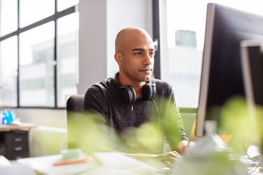 Business man working on desktop pc in office