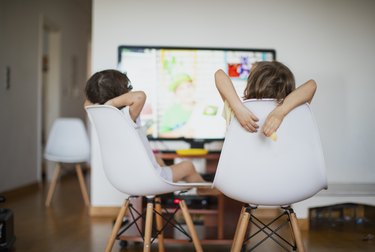 Kids eating in front of a television