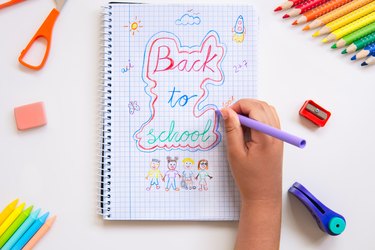 Kid drawing back to school on a notebook