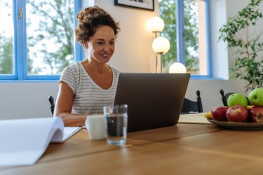 Woman working from home at her apartment