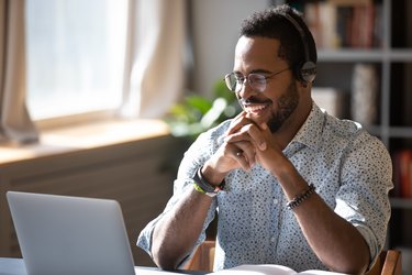 Smiling biracial businessman holding video call with clients partners.