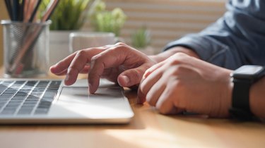 Close-up of man hands using and typing keyboard of laptop computer on office desk. Workspace, businessman working project creative idea for job online network. Business finance and technology concept.