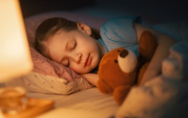 child is sleeping in the bed