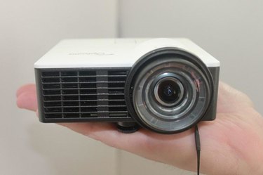 Picture of the Optoma ML750ST in the palm of someone's hand