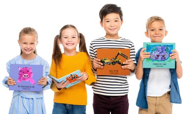 four kids holding books