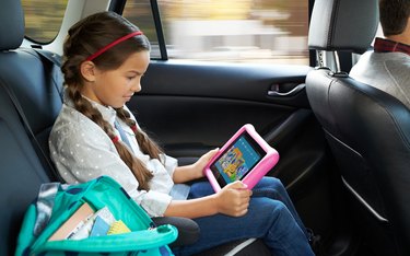 girl with tablet in car