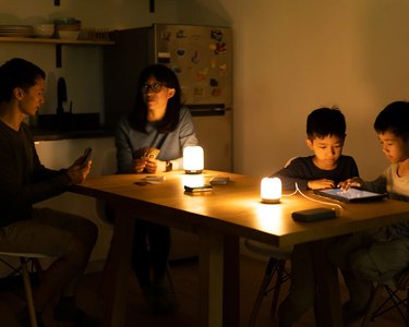 family using lights around table