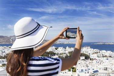 Beautiful woman taking photo with a digital tablet