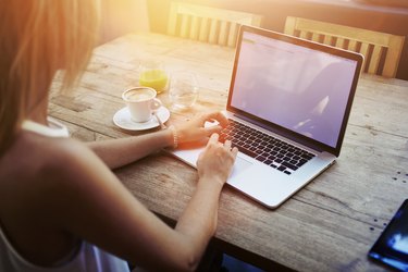 Female student working on net-book after her lectures in University