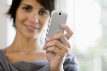 Businesswoman holding cell phone