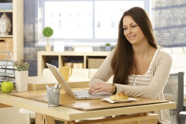 Young woman with laptop in the morning