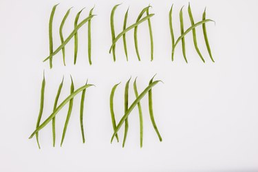 String beans in tally chart against white background