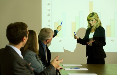 A woman giving a presentation on a projector