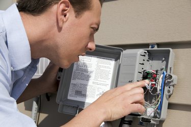 Man inspecting wiring box