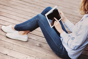 Girl using digital tablet outdoors