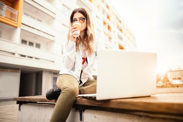 Young woman with a book and coffee.