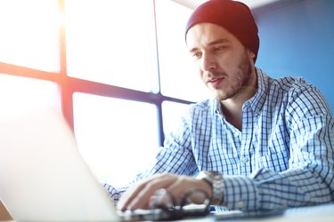 Handsome man working from his home office. Analyze business plans