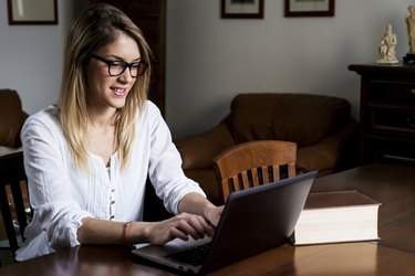 Young girl studying on the computer.