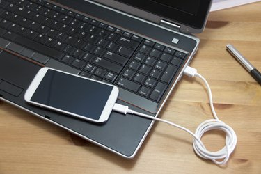 Smartphone connected to a Laptop computer