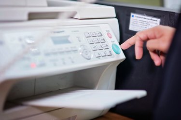 Businessman working with printer in the office ./Focus selection