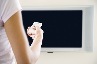 Hand holding tv remote control