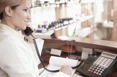 Hairdresser taking an appointment over the phone