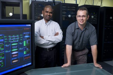 Portrait of two technicians standing in a server room