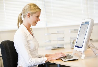 Businesswoman typing on computer