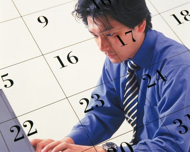Businessman using laptop and image of calendar, CG, composition, side view