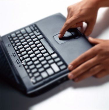 person using the touch pad on a laptop