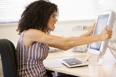 Businesswoman shaking computer