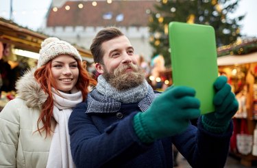 couple taking selfie with tablet pc in old town