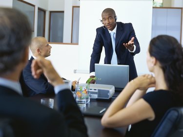 Three businessmen and a businesswoman in a meeting