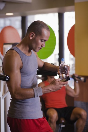 Man with cell phone in gym