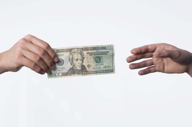 Hands exchanging money
