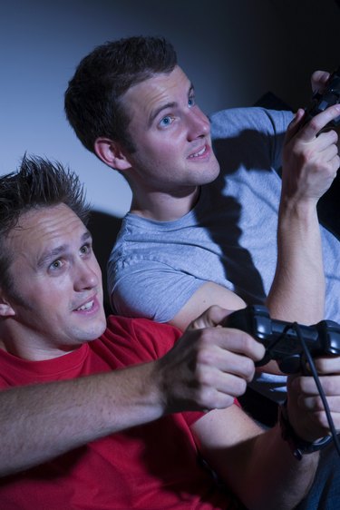 Two men playing on a games console