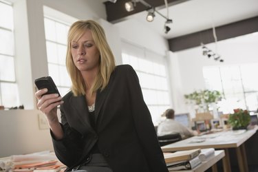 Woman text messaging with cellular phone