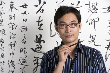 Chinese artist holding paintbrush