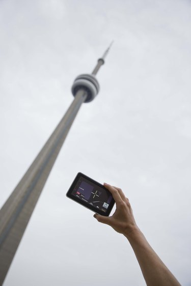 Person taking picture of CN Tower in Toronto, Ontario, Canada