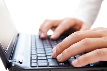 Businessman working on laptop over white