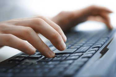 Close-up of typing female hands on keyboard