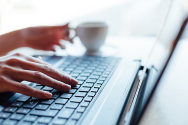 Closeup of woman using laptop