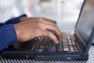 Man typing on laptop computer