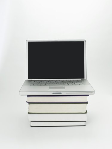 Stack of books and laptop computer